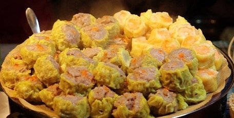 Jumbo siomai stacked on a large serving plate.