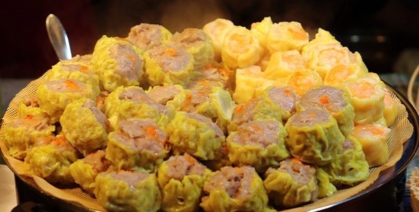 Jumbo siomai stacked on a large serving plate.