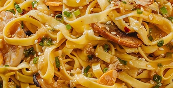 Garlic butter pancit topped with chicken and mushrooms.