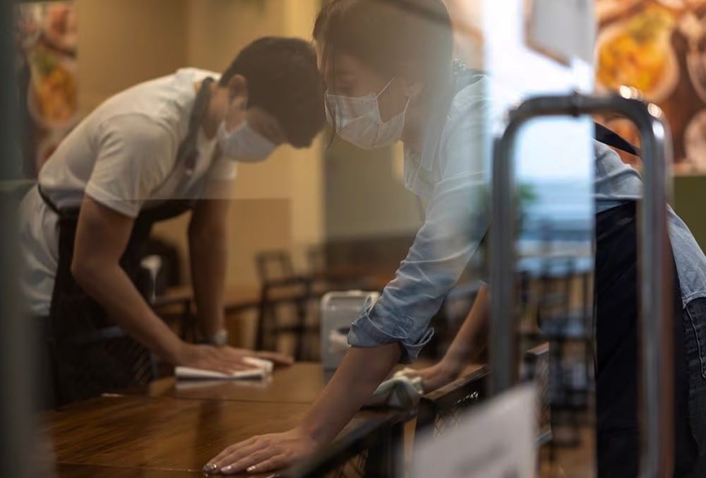 Restaurant staff cleaning tables. Restaurant staff cleaning tables.