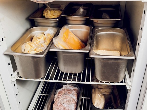  A professional freezer with various ingredients.