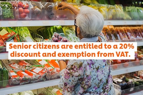 A senior selects fresh produce at the grocery. A senior selects fresh produce at the grocery.