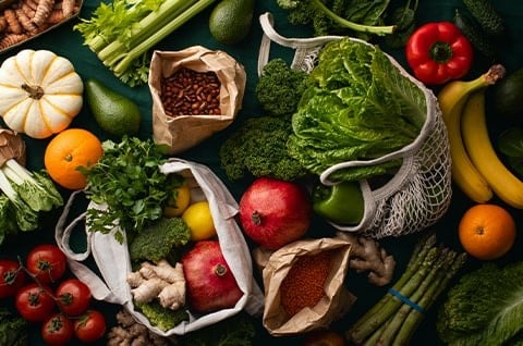 A selection of fresh fruits and vegetables on a black counter. A selection of fresh fruits and vegetables on a black counter.