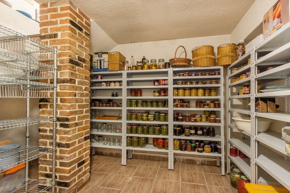 A pantry storage room lined with floor-to-ceiling shelves with all kinds of ingredients A pantry storage room lined with floor-to-ceiling shelves with all kinds of ingredients