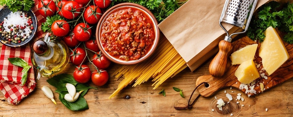 Varied food ingredients laid out on a wooden table Varied food ingredients laid out on a wooden table