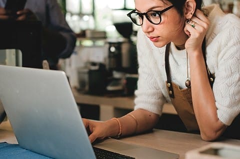 A business owner using her laptop at work. A business owner using her laptop at work.