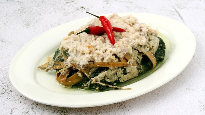 Pinangat with coconut and chilies served in a white platter.