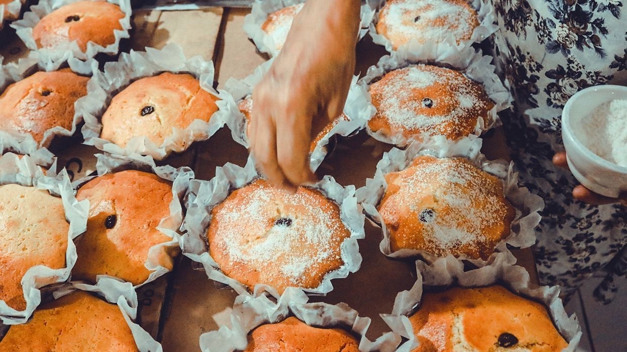 Freshly baked torta Cebuana being sprinkled with sugar. Freshly baked torta Cebuana being sprinkled with sugar.