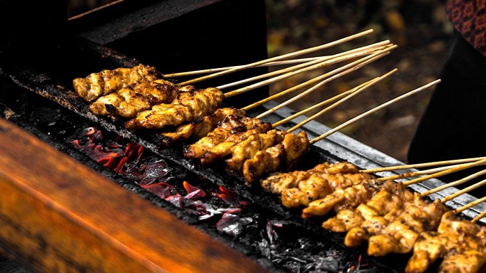 Chicken satti grilling on charcoal.