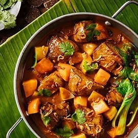 Freshly cooked beef rendang with vegetables in a pot. Freshly cooked beef rendang with vegetables in a pot.
