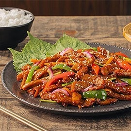 Korean pork stir-fry in spicy gochujang sauce with vegetables. Korean pork stir-fry in spicy gochujang sauce with vegetables.