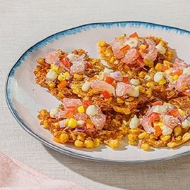 Corn and shrimp okoy topped with pomelo salad. Corn and shrimp okoy topped with pomelo salad.