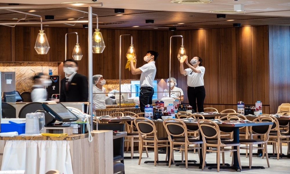 Restaurant staff cleaning every surface and fixture in the dining room Restaurant staff cleaning every surface and fixture in the dining room