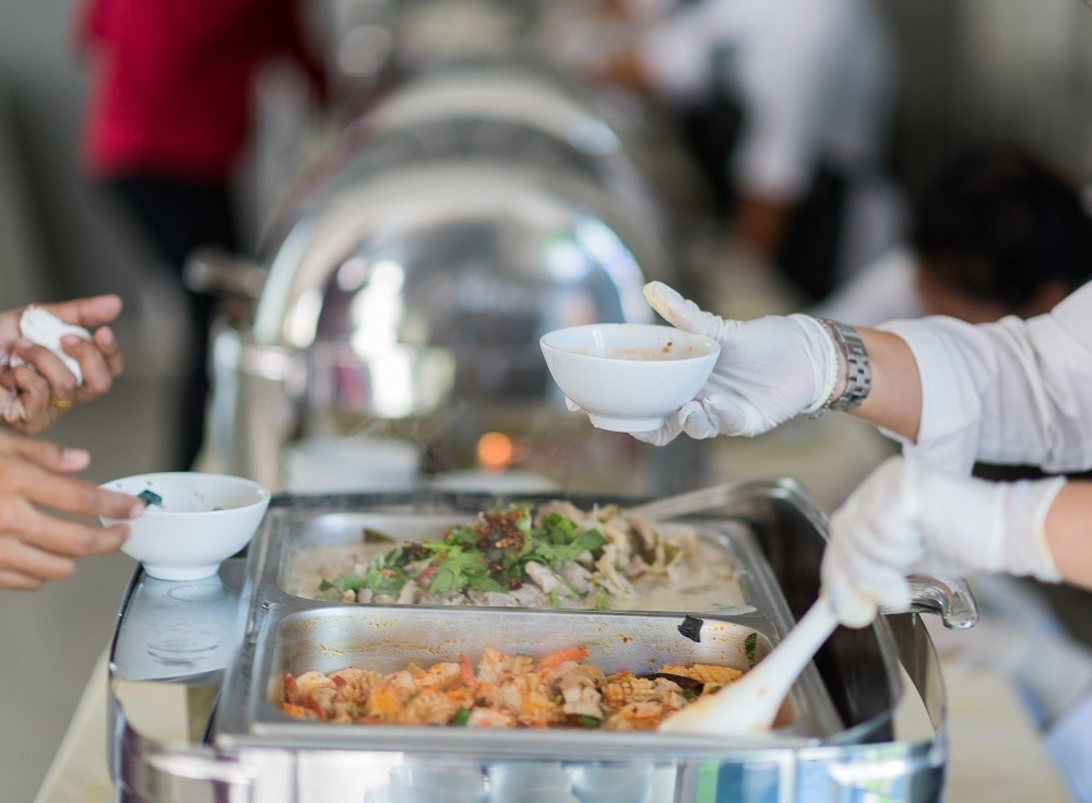 Staff wearing proper service attire and gloves when serving guests at wedding buffets Staff wearing proper service attire and gloves when serving guests at wedding buffets