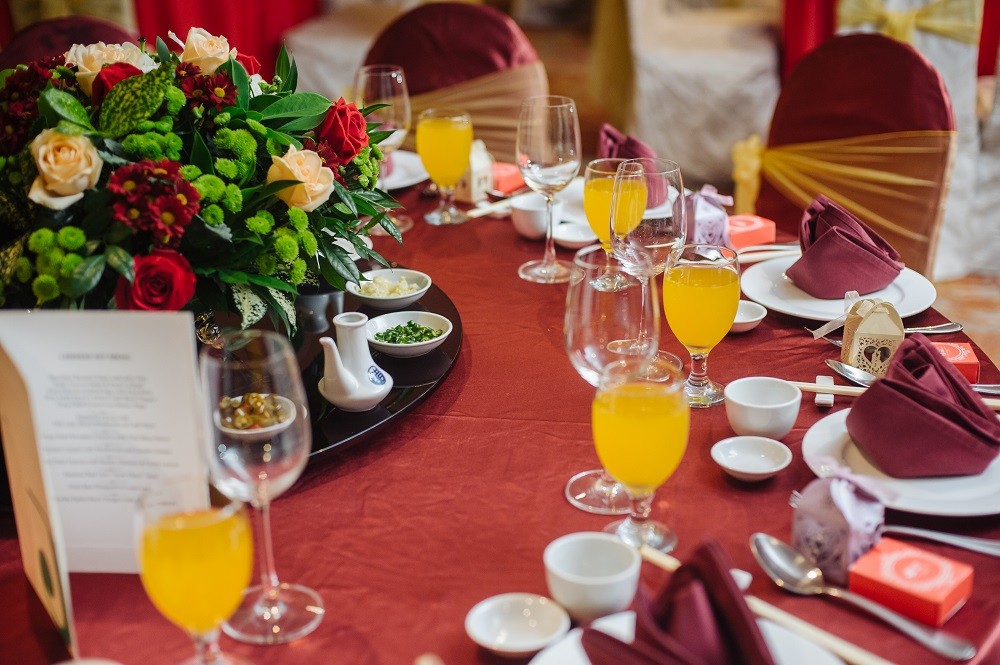 A closeup photo of the main table setting at a wedding reception A closeup photo of the main table setting at a wedding reception